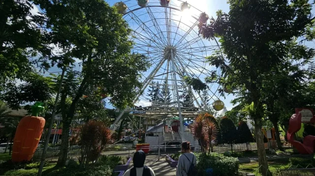 Dua orang pengunjung minikmati waktu di Alun-Alun Kota Batu yang merupakan salah satu tempat wisata milik pemerintah kota setempat. ANTARA